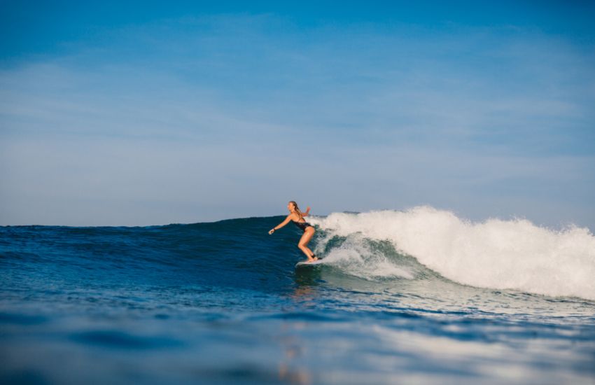 Girl surfing in Aruba