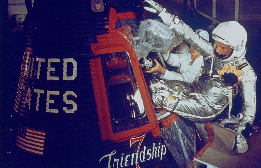 john glenn entering friendship capsule to orbit earth