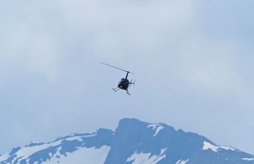 helicopter flying high over mountain